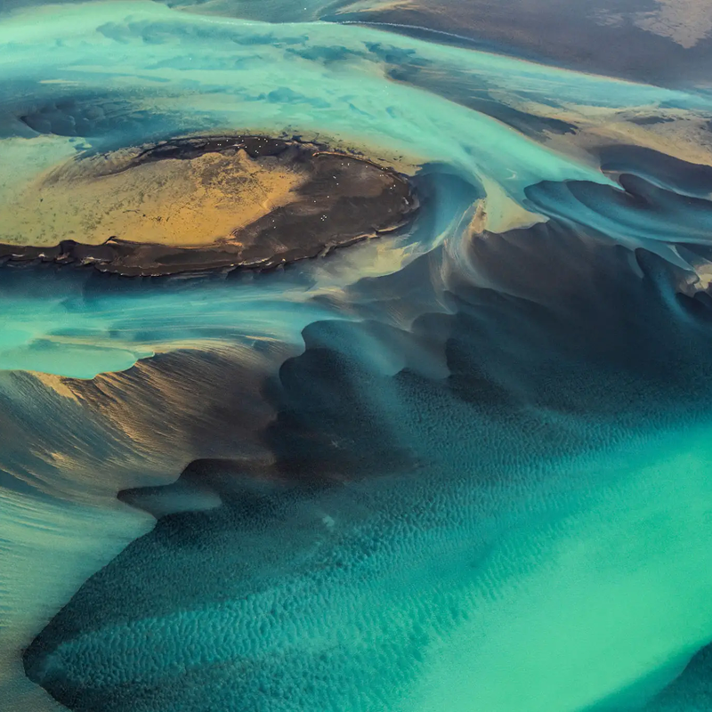 Aerial view of vibrant turquoise river delta.